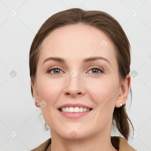 Joyful white young-adult female with medium  brown hair and grey eyes