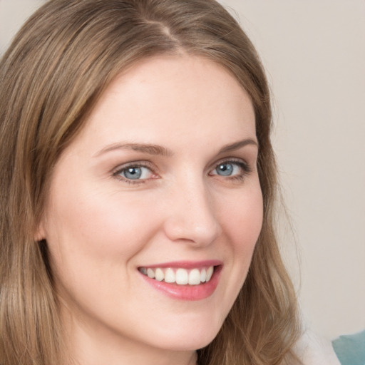 Joyful white young-adult female with long  brown hair and grey eyes