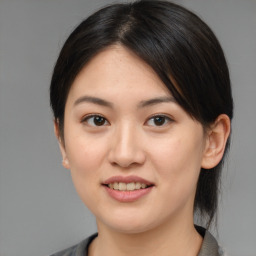 Joyful asian young-adult female with medium  brown hair and brown eyes