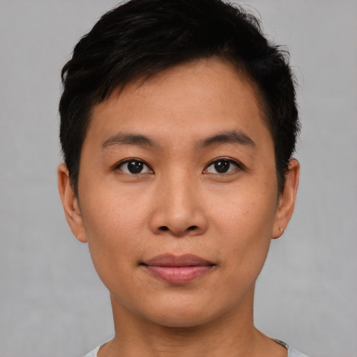 Joyful asian young-adult male with short  brown hair and brown eyes