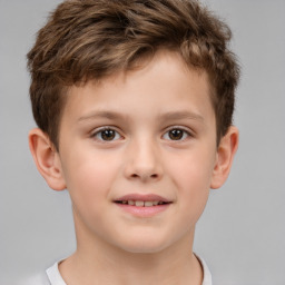 Joyful white child male with short  brown hair and brown eyes