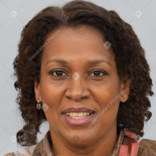 Joyful black adult female with medium  brown hair and brown eyes