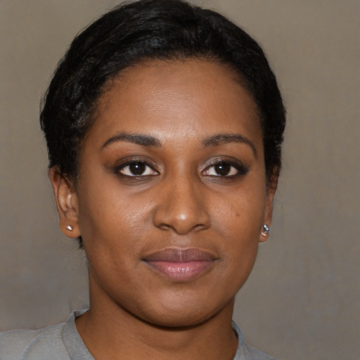 Joyful black young-adult female with short  brown hair and brown eyes