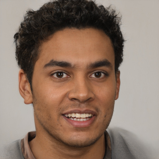 Joyful latino young-adult male with short  brown hair and brown eyes