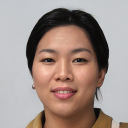 Joyful asian young-adult female with short  black hair and brown eyes