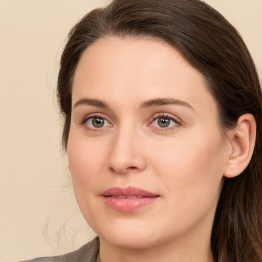 Joyful white young-adult female with medium  brown hair and green eyes