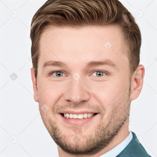 Joyful white young-adult male with short  brown hair and grey eyes