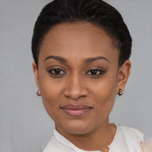 Joyful black young-adult female with short  black hair and brown eyes