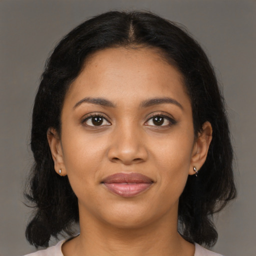 Joyful black young-adult female with medium  black hair and brown eyes
