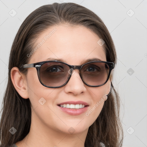 Joyful white young-adult female with long  brown hair and blue eyes