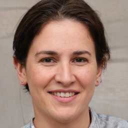 Joyful white adult female with short  brown hair and brown eyes