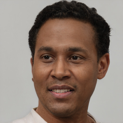 Joyful latino adult male with short  black hair and brown eyes