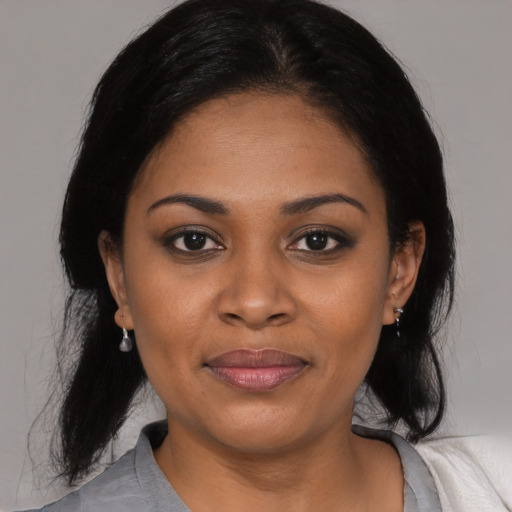Joyful black young-adult female with medium  black hair and brown eyes