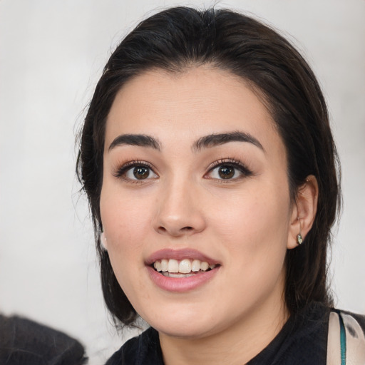 Joyful white young-adult female with medium  black hair and brown eyes