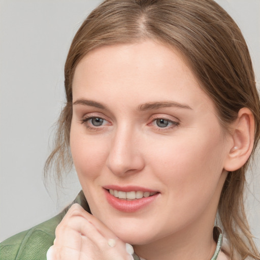 Joyful white young-adult female with medium  brown hair and blue eyes