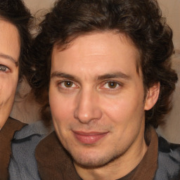 Joyful white adult male with medium  brown hair and brown eyes