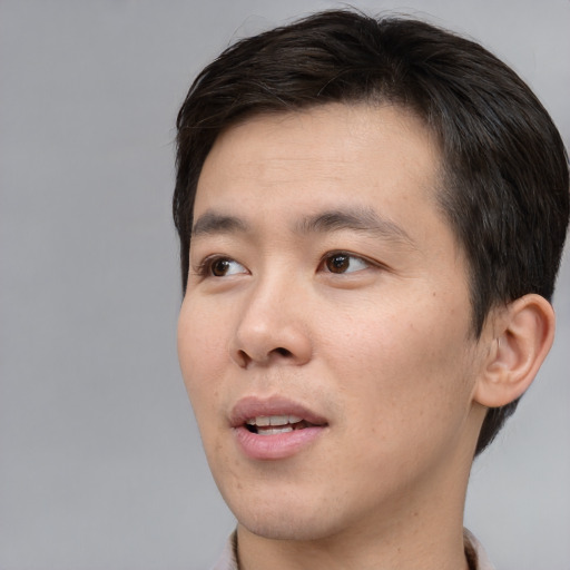 Neutral asian young-adult male with short  brown hair and brown eyes
