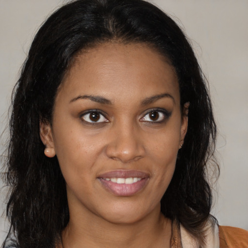 Joyful black young-adult female with medium  brown hair and brown eyes