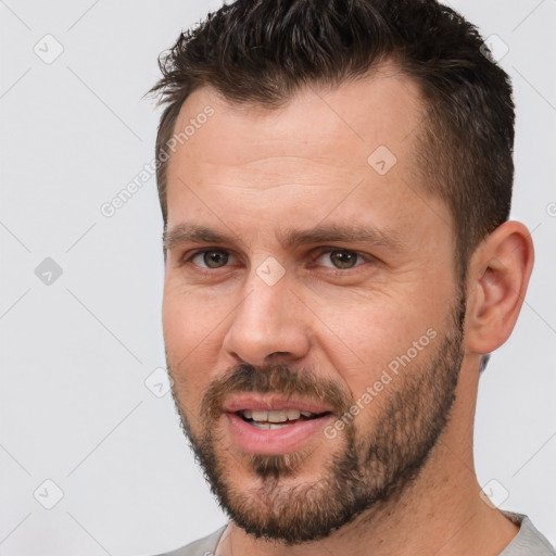 Joyful white adult male with short  brown hair and brown eyes