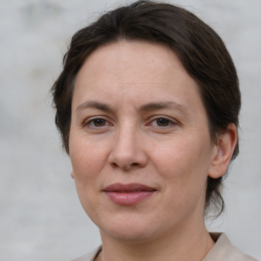 Joyful white adult female with short  brown hair and brown eyes