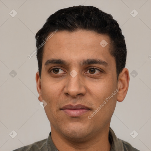 Joyful white young-adult male with short  black hair and brown eyes