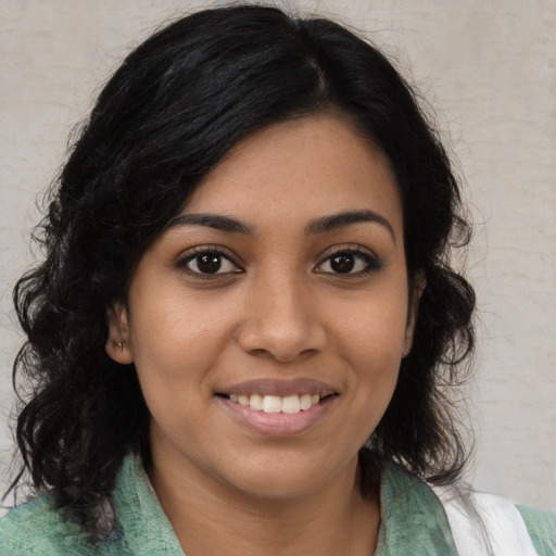 Joyful latino young-adult female with medium  black hair and brown eyes