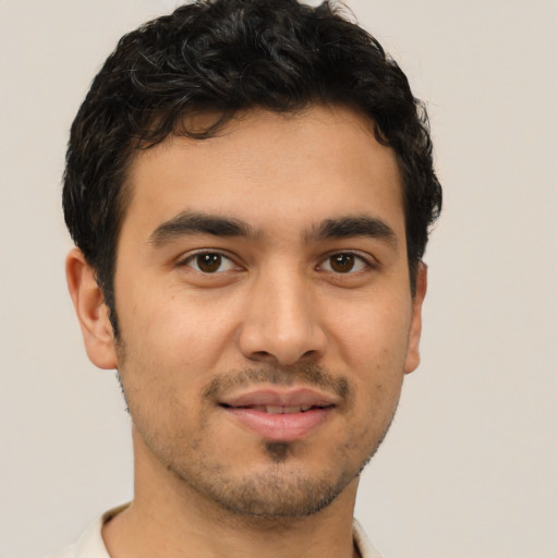 Joyful latino young-adult male with short  brown hair and brown eyes