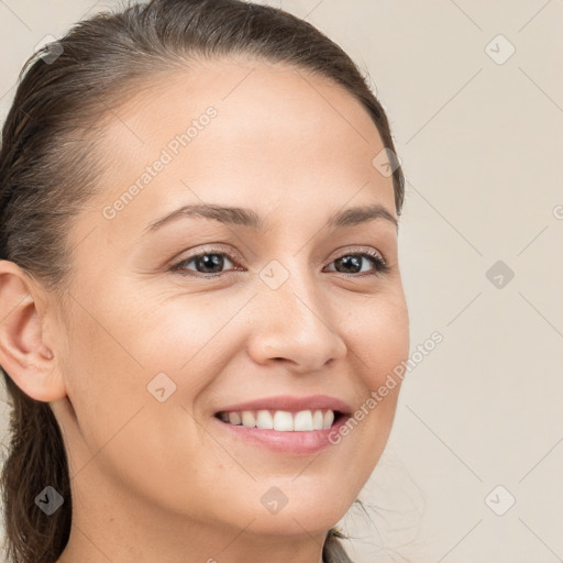 Joyful white young-adult female with long  brown hair and brown eyes