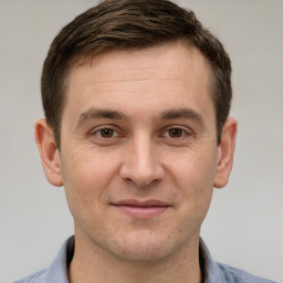 Joyful white adult male with short  brown hair and grey eyes