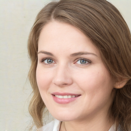 Joyful white young-adult female with medium  brown hair and green eyes