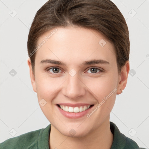 Joyful white young-adult female with short  brown hair and grey eyes