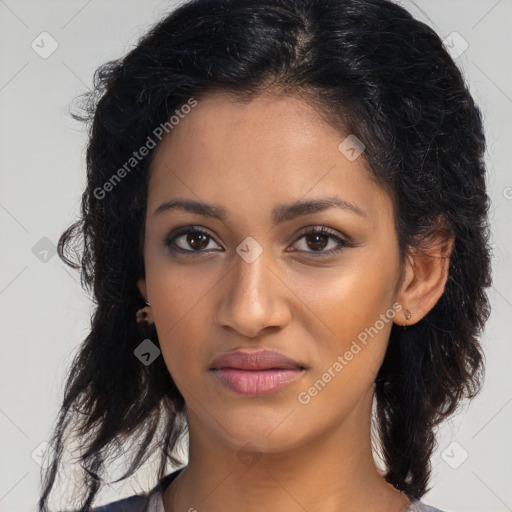 Joyful black young-adult female with long  brown hair and brown eyes