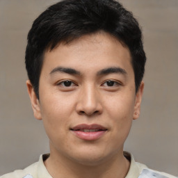 Joyful asian young-adult male with short  black hair and brown eyes