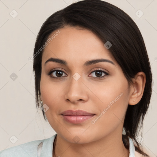 Joyful latino young-adult female with medium  brown hair and brown eyes