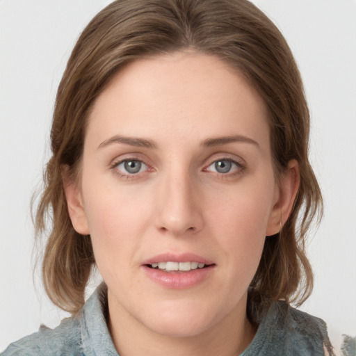 Joyful white young-adult female with medium  brown hair and blue eyes