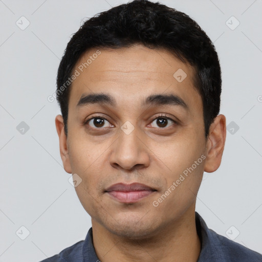 Joyful latino young-adult male with short  black hair and brown eyes