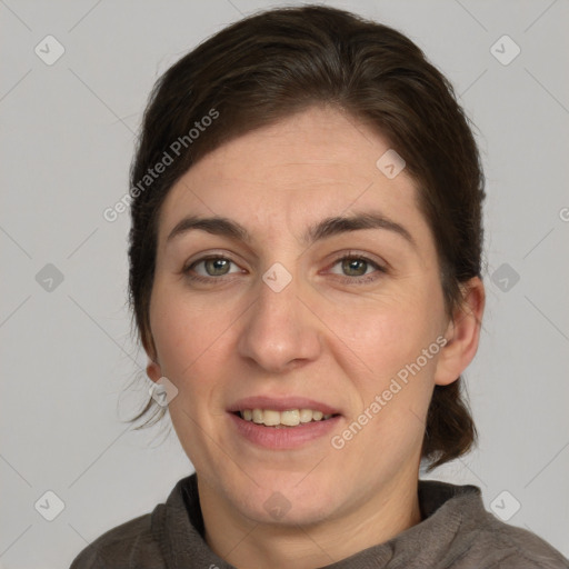 Joyful white adult female with medium  brown hair and brown eyes