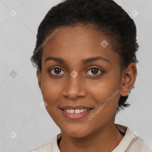 Joyful black young-adult female with short  brown hair and brown eyes