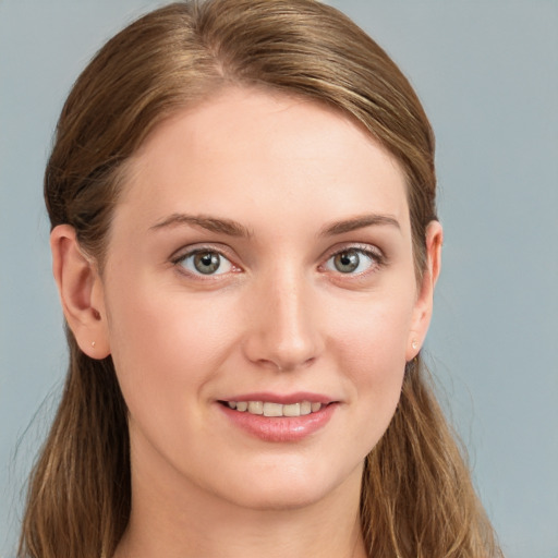 Joyful white young-adult female with long  brown hair and blue eyes