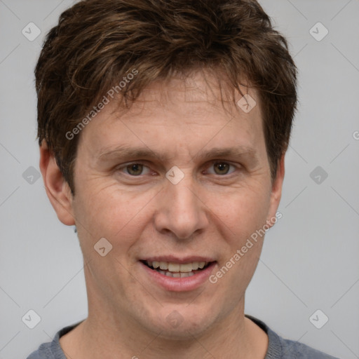 Joyful white adult male with short  brown hair and grey eyes