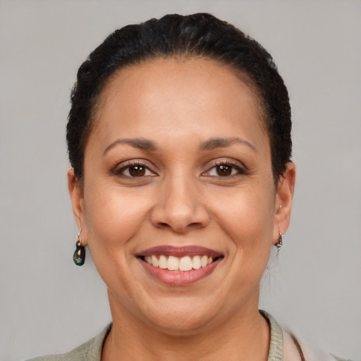 Joyful latino adult female with short  brown hair and brown eyes
