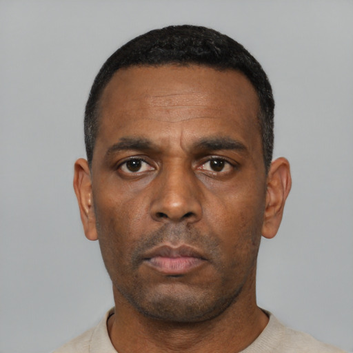 Neutral black adult male with short  black hair and brown eyes
