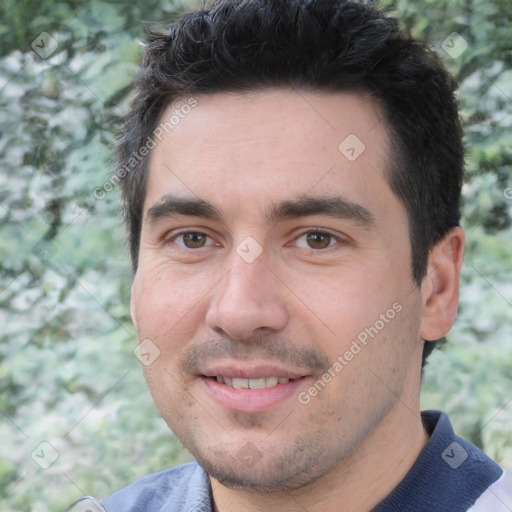 Joyful white young-adult male with short  black hair and brown eyes