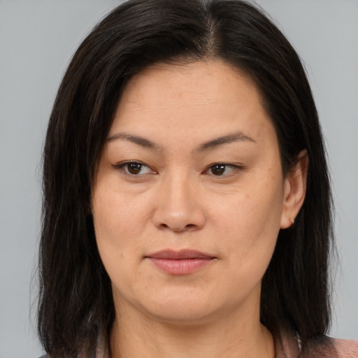 Joyful asian adult female with medium  brown hair and brown eyes