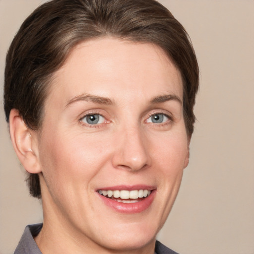 Joyful white young-adult female with short  brown hair and grey eyes