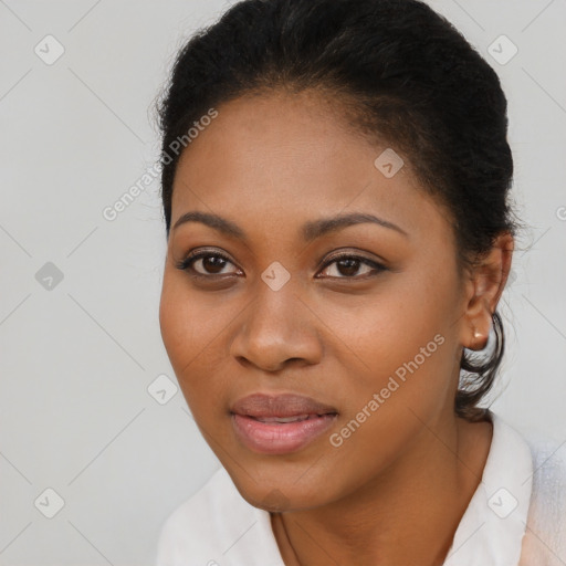 Joyful black young-adult female with long  black hair and brown eyes