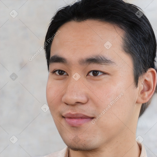 Joyful asian young-adult male with short  black hair and brown eyes