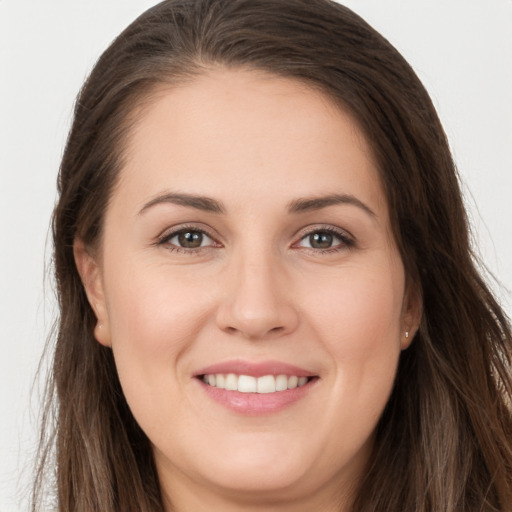 Joyful white young-adult female with long  brown hair and grey eyes