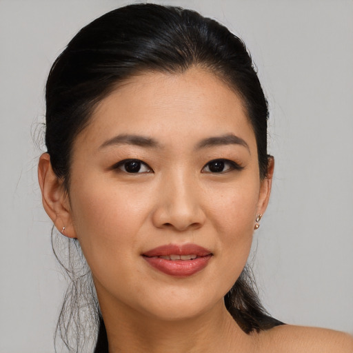 Joyful asian young-adult female with medium  brown hair and brown eyes