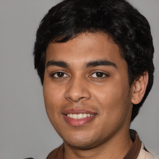 Joyful latino young-adult male with short  black hair and brown eyes